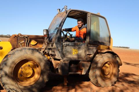 Pacific worker on tractor