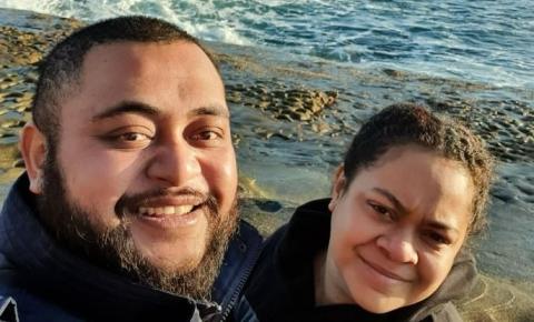 A Fijian man and woman standing on a beach.