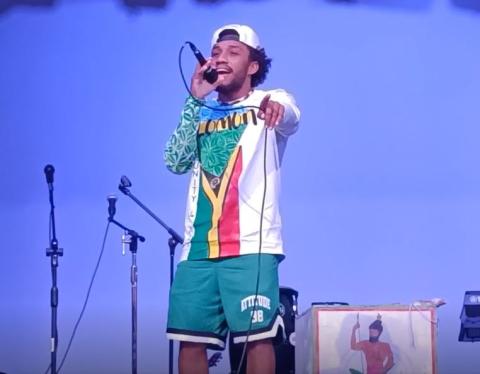 A Solomon Islands man sings on a stage.