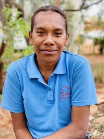 A woman in a uniform smiling at the camera