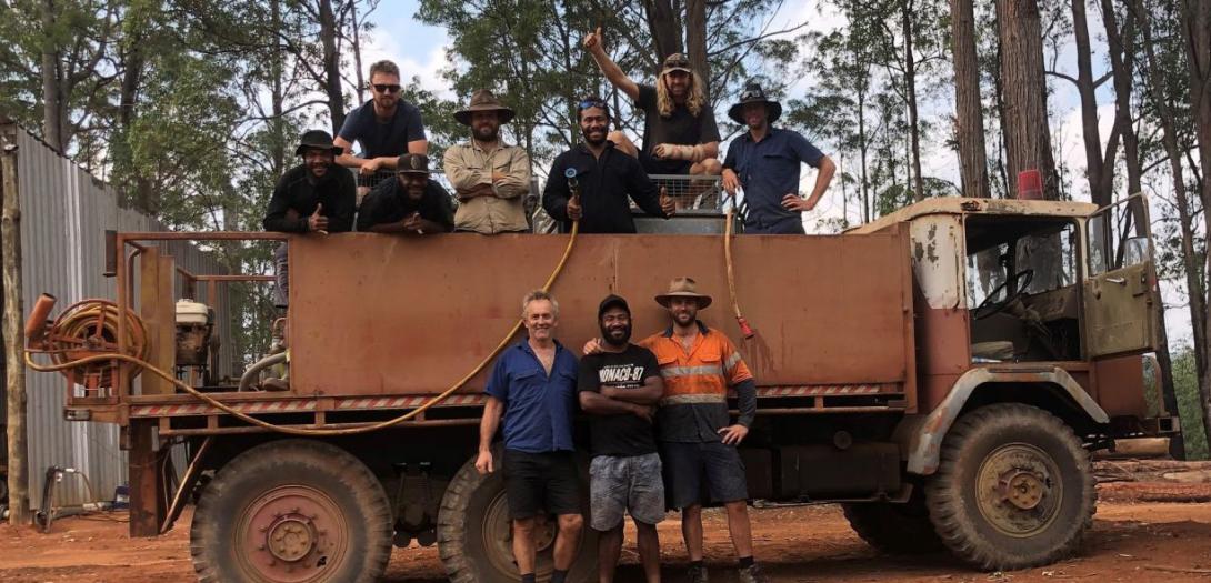 Aussie Orchards managing director Colin Foyster (front, left), with a group of Australian and Papua New Guinean workers and the fire truck they used when fires came close to the farm. Photo: Colin Foyster