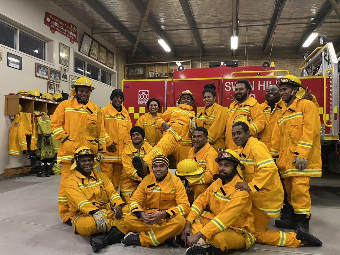 Fijian volunteer firefighters in a group smiling 